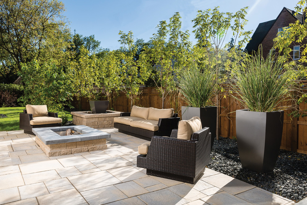 Inspiration for a mid-sized rustic backyard concrete patio remodel with a fire pit and no cover