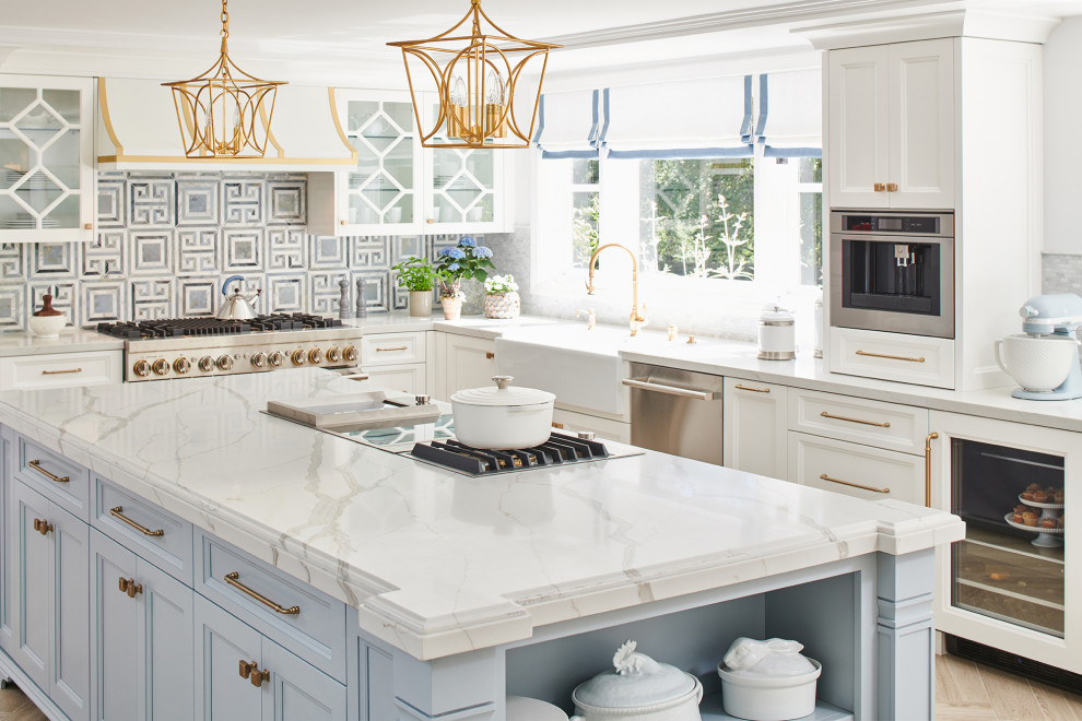 Inspiration for a transitional eat-in kitchen in Los Angeles with white cabinets, quartz benchtops, blue splashback, stainless steel appliances, beige floor, white benchtop, a farmhouse sink, beaded inset cabinets, marble splashback and porcelain floors.