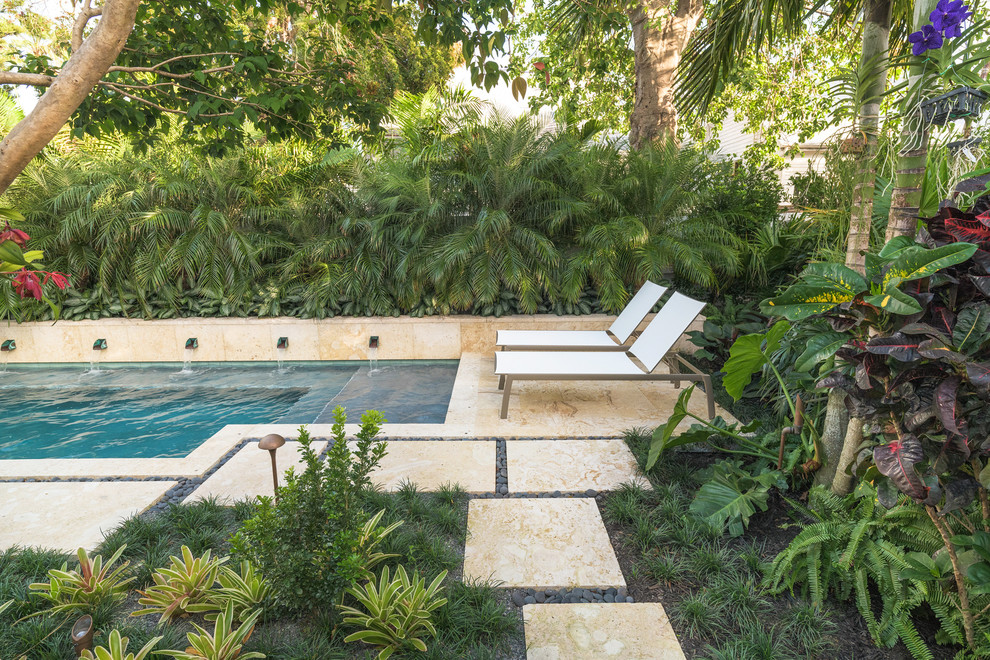 Example of a small island style home design design in Miami