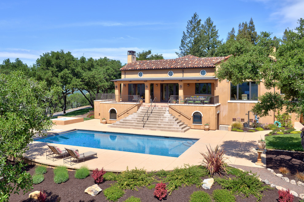 Inspiration for a large mediterranean backyard concrete paver and rectangular lap hot tub remodel in San Francisco