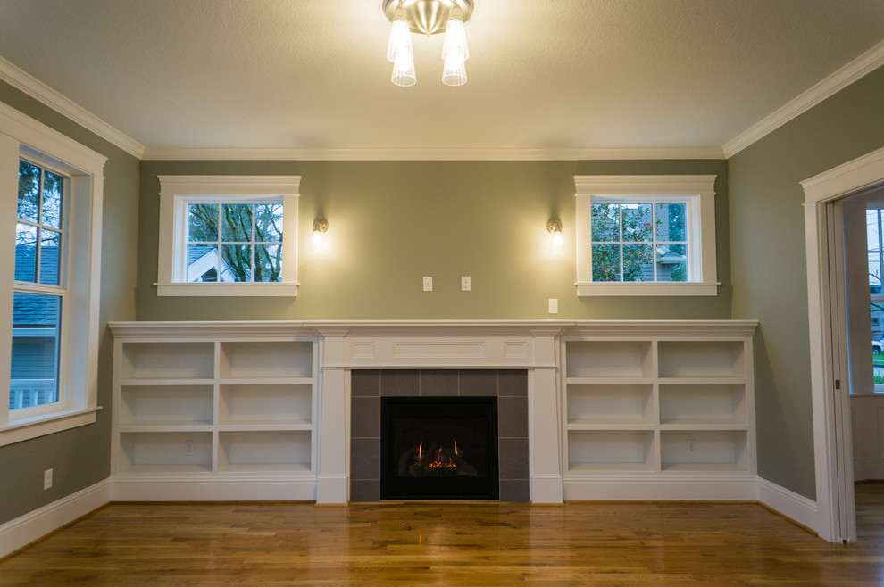 Inspiration for a mid-sized arts and crafts open concept family room in Portland with light hardwood floors, a standard fireplace, a tile fireplace surround and a wall-mounted tv.
