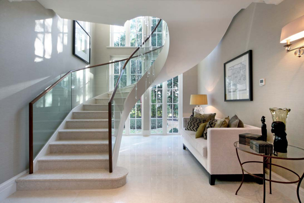 Inspiration for a contemporary spiral wood railing staircase in Other with limestone treads, limestone risers, wallpapered walls and feature lighting.