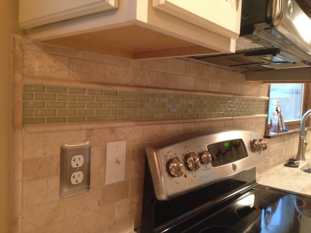 Example of a mid-sized transitional l-shaped medium tone wood floor kitchen design in Cincinnati with a double-bowl sink, raised-panel cabinets, white cabinets, granite countertops, beige backsplash, ceramic backsplash and stainless steel appliances