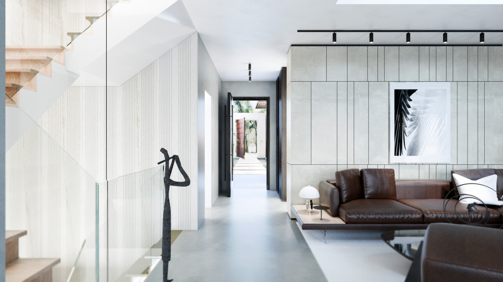 Photo of a large contemporary foyer in Rome with grey walls, concrete floors, a single front door, a dark wood front door, grey floor, recessed and panelled walls.