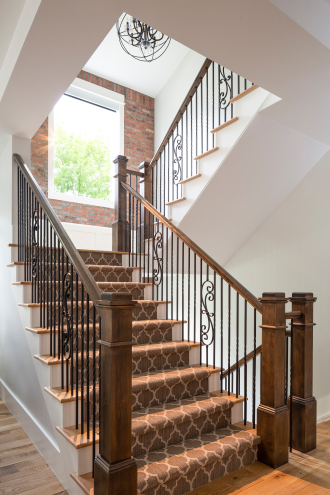 Design ideas for a large country wood u-shaped staircase in Denver with wood risers and mixed railing.