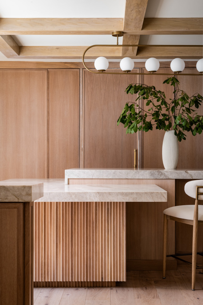 Large transitional kitchen photo in Charlotte with recessed-panel cabinets, wood countertops, paneled appliances and an island