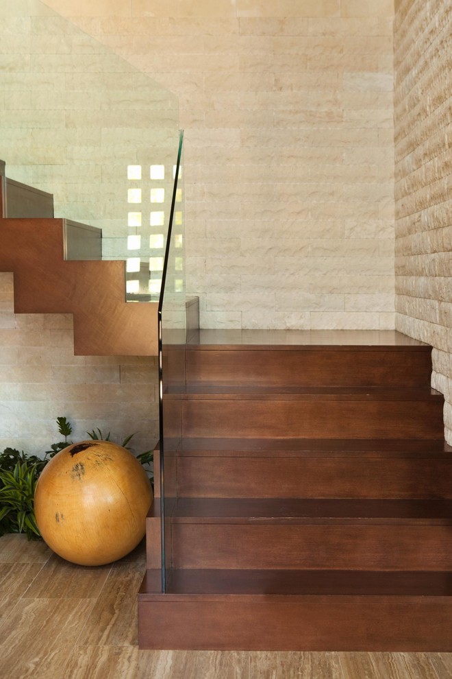 Design ideas for a contemporary floating staircase in Los Angeles with glass railing.