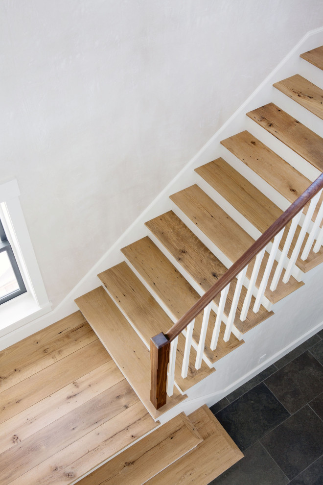 Inspiration for a large country wood staircase in Boston with wood railing.