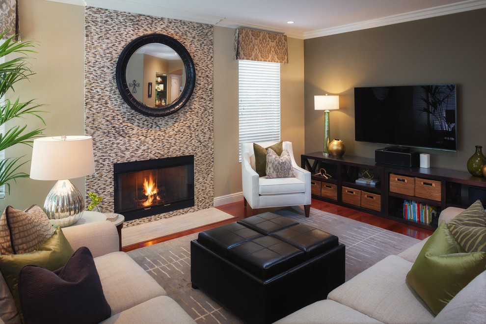 Design ideas for a large contemporary formal enclosed living room in San Diego with green walls, medium hardwood floors, a standard fireplace, a tile fireplace surround and a freestanding tv.