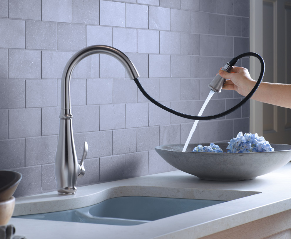 Eat-in kitchen - mid-sized transitional single-wall concrete floor eat-in kitchen idea with a double-bowl sink, gray backsplash, subway tile backsplash, stainless steel appliances, flat-panel cabinets, gray cabinets, solid surface countertops and an island