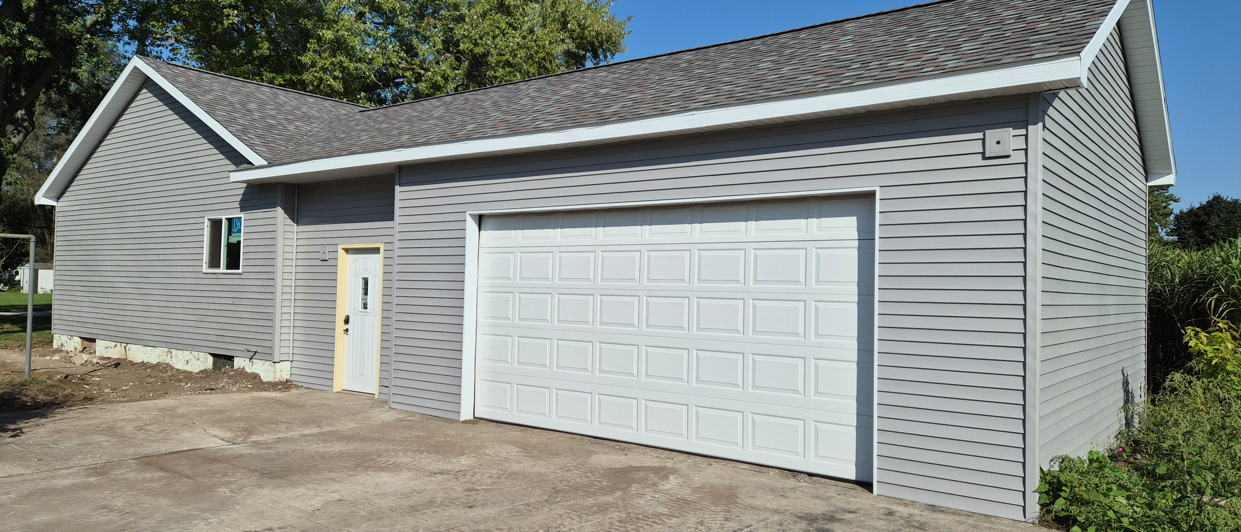 Garage - mid-sized attached two-car garage idea in Other