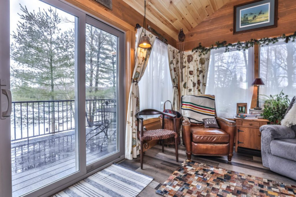 Mountain style vinyl floor and brown floor sunroom photo in Other with a standard ceiling