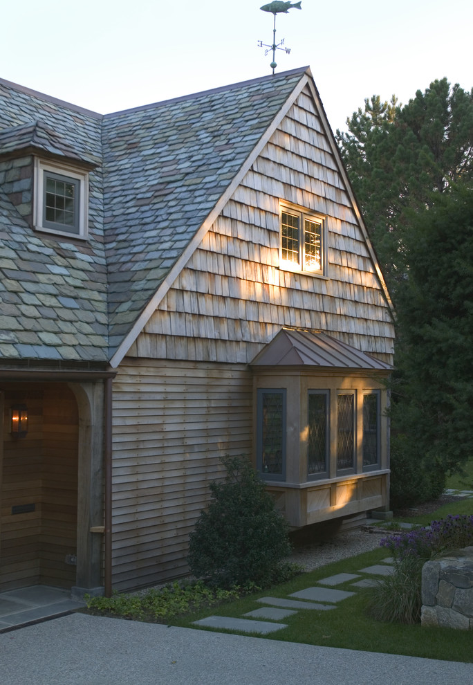 Photo of a large traditional two-storey exterior in Boston with wood siding and a gable roof.