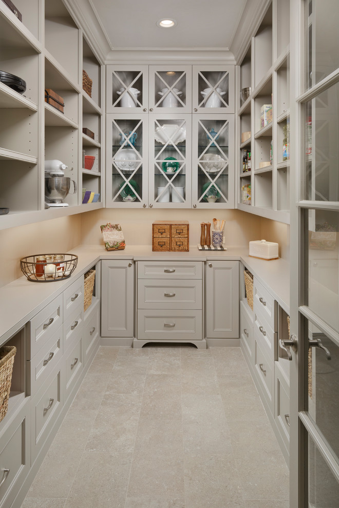 Design ideas for a traditional u-shaped kitchen pantry in Houston with glass-front cabinets, beige cabinets, beige splashback, beige floor, quartzite benchtops and porcelain floors.