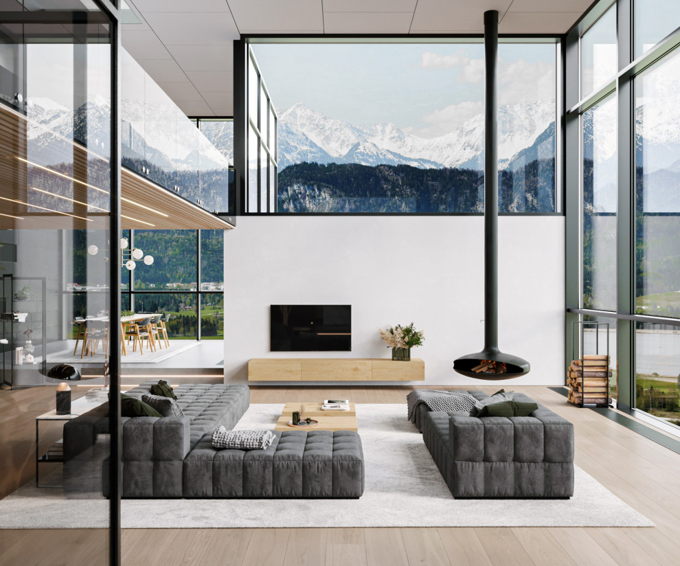 Modelo de sala de estar tipo loft minimalista grande con suelo de madera clara, chimeneas suspendidas, televisor colgado en la pared y papel pintado