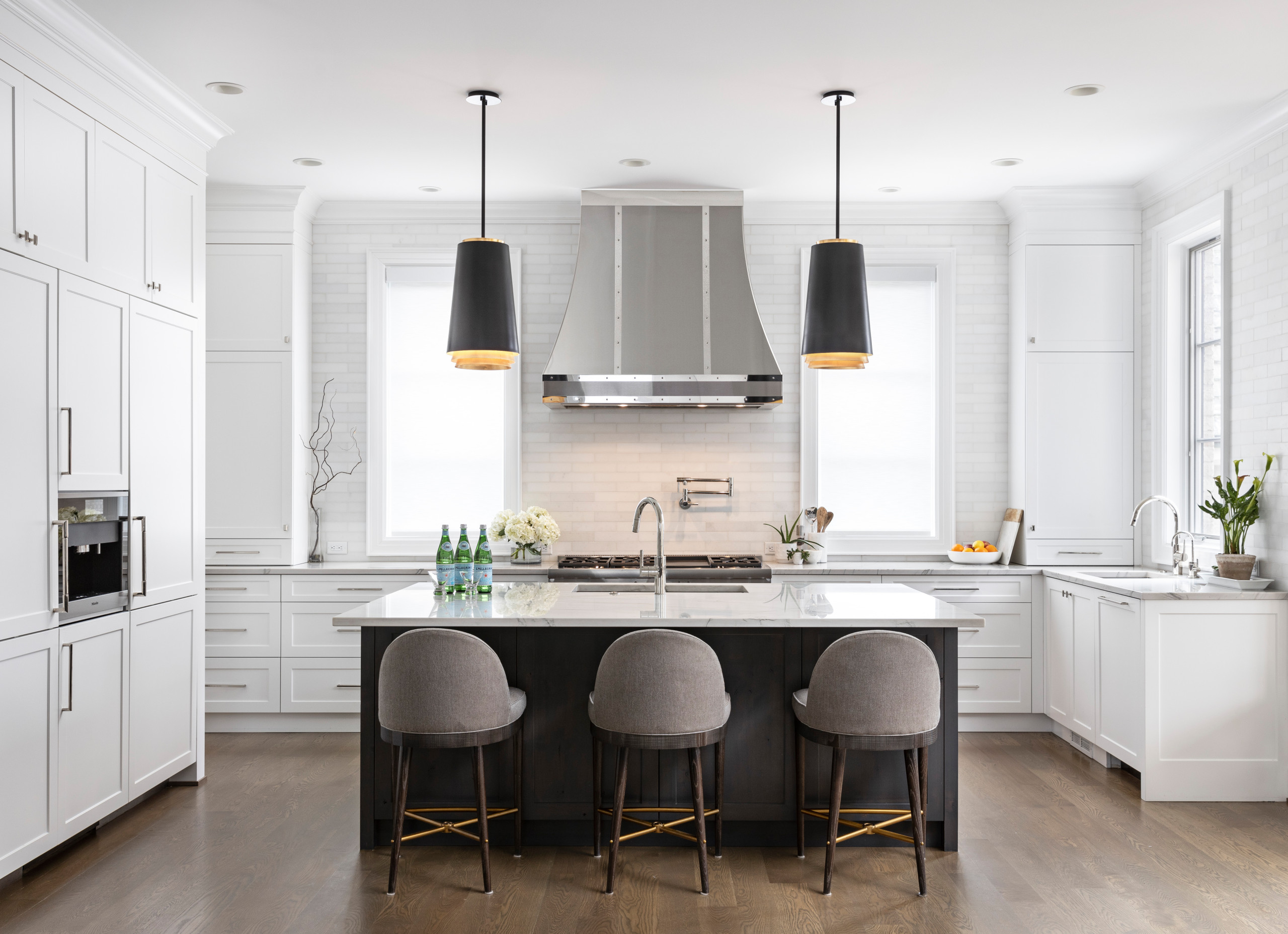 Serenity in the Kitchen. When working with an open floor plan, it’s essential to tie in these spaces with the rest of the Home. The custom metal hood becomes the star of the show, and you can be sure