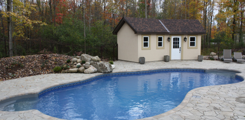 Inspiration for a large backyard stamped concrete and freeform pool remodel
