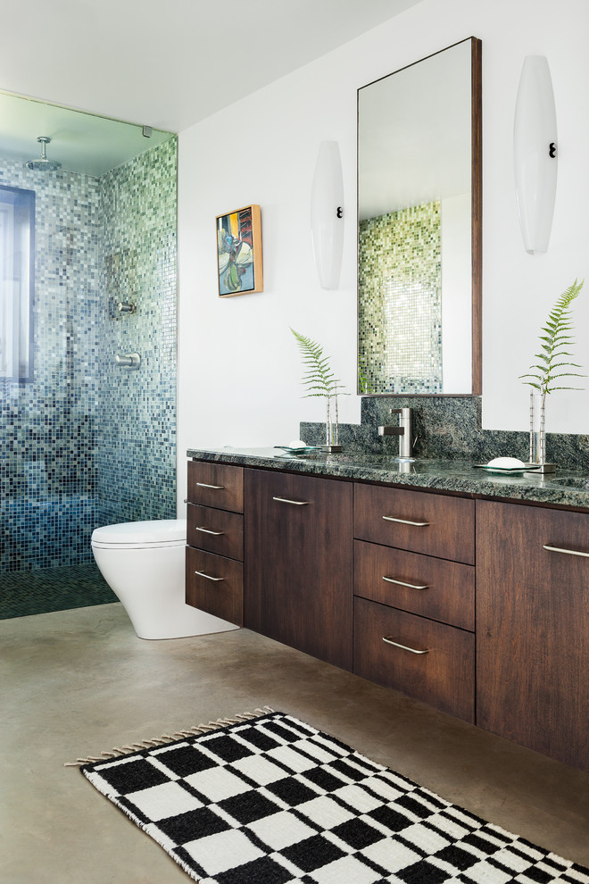Design ideas for a contemporary 3/4 bathroom in Portland Maine with an integrated sink, flat-panel cabinets, dark wood cabinets, an alcove shower, a one-piece toilet, multi-coloured tile, mosaic tile, white walls and concrete floors.