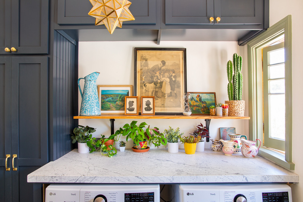 Inspiration for a mid-sized eclectic single-wall dedicated laundry room in Los Angeles with shaker cabinets, blue cabinets, marble benchtops, a side-by-side washer and dryer and white benchtop.