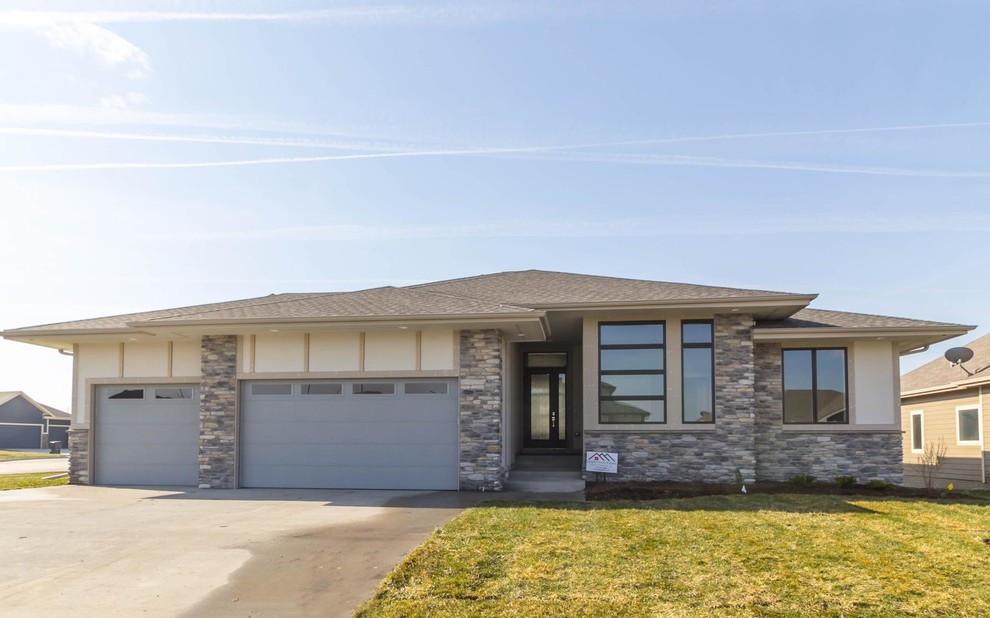 Mid-sized transitional beige two-story mixed siding exterior home photo with a hip roof