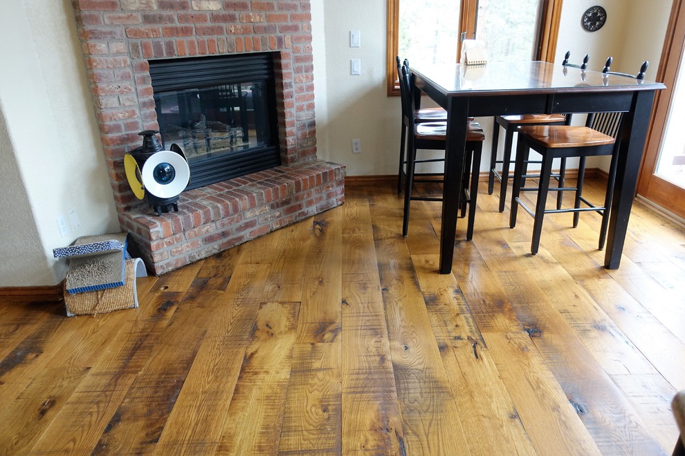 Example of a huge mountain style open concept medium tone wood floor home design design in Denver with beige walls, a standard fireplace and a brick fireplace