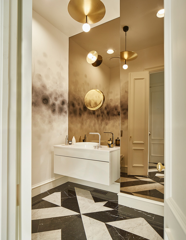 This is an example of a mid-sized modern 3/4 bathroom in Dallas with flat-panel cabinets, white cabinets, a wall-mount toilet, black and white tile, marble, multi-coloured walls, marble floors, a drop-in sink, quartzite benchtops, a freestanding tub, a curbless shower, white floor and a hinged shower door.