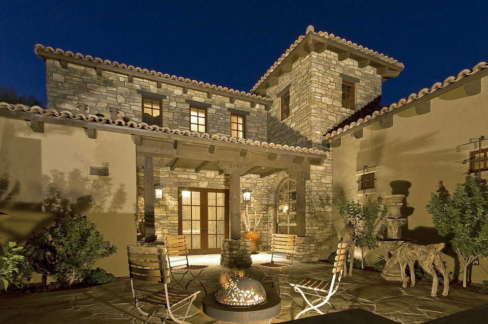 This is an example of a mediterranean patio in Phoenix with a fire feature.