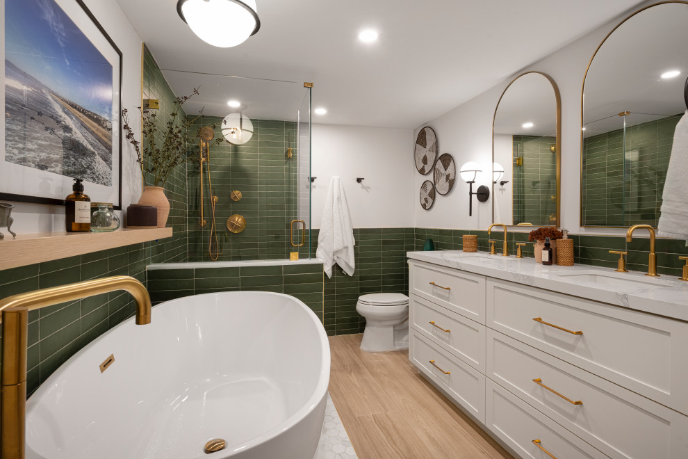 Design ideas for a classic bathroom in Miami with shaker cabinets, white cabinets, a freestanding bath, a two-piece toilet, green tiles, white walls, a submerged sink, beige floors, white worktops, double sinks and a built in vanity unit.