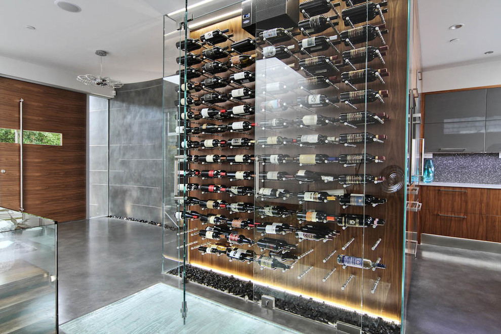 Mid-sized modern wine cellar in Vancouver with storage racks.