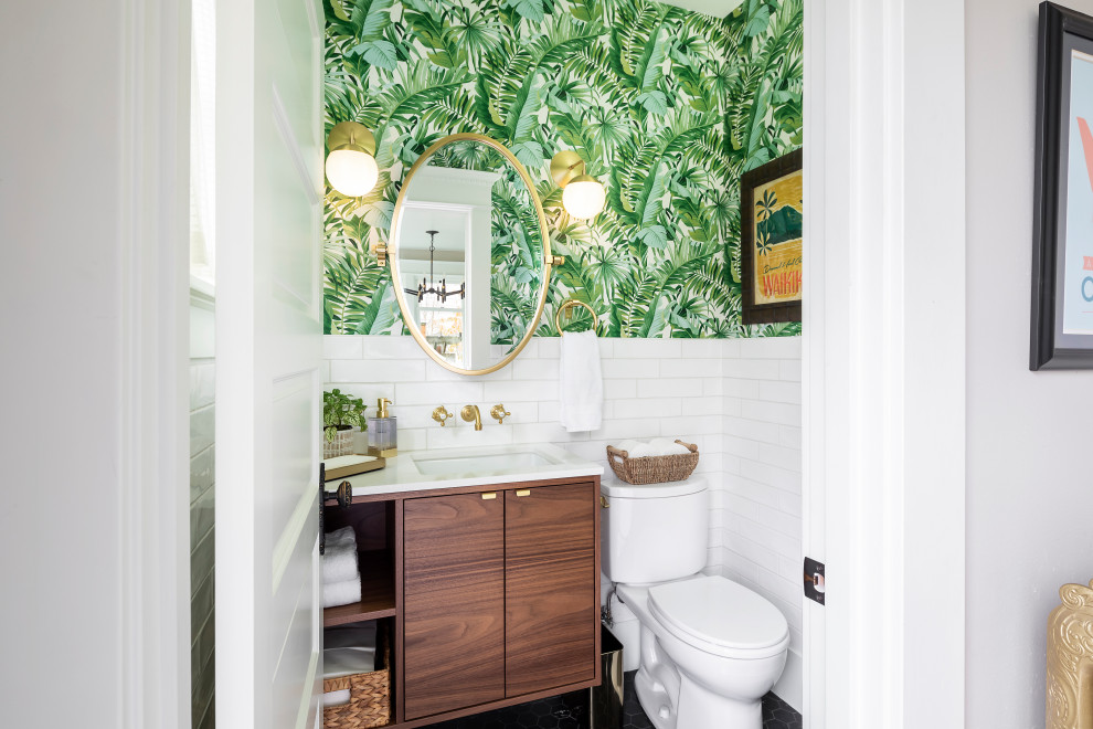 This is an example of a small world-inspired bathroom in Seattle with flat-panel cabinets, medium wood cabinets, a two-piece toilet, white tiles, ceramic tiles, green walls, marble flooring, a submerged sink, engineered stone worktops, black floors, white worktops, a single sink, a floating vanity unit and wallpapered walls.