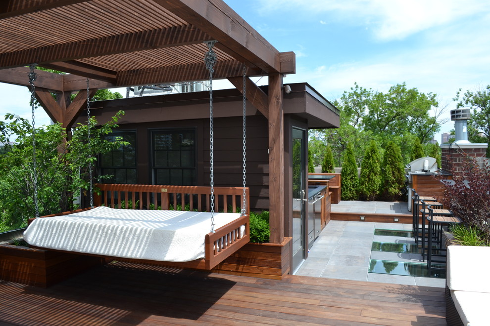 This is an example of a large contemporary rooftop and rooftop deck in Chicago with a pergola.