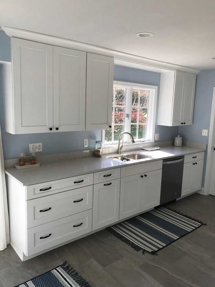 Mid-sized transitional porcelain tile and gray floor eat-in kitchen photo with a double-bowl sink, shaker cabinets, white cabinets, quartz countertops, stainless steel appliances, no island and gray countertops