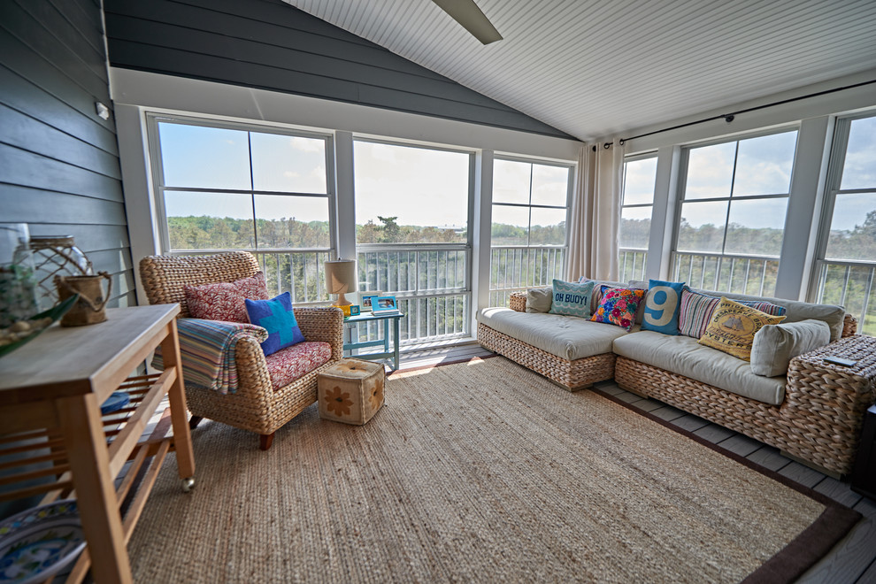 Small beach style sunroom in Other with grey floor.