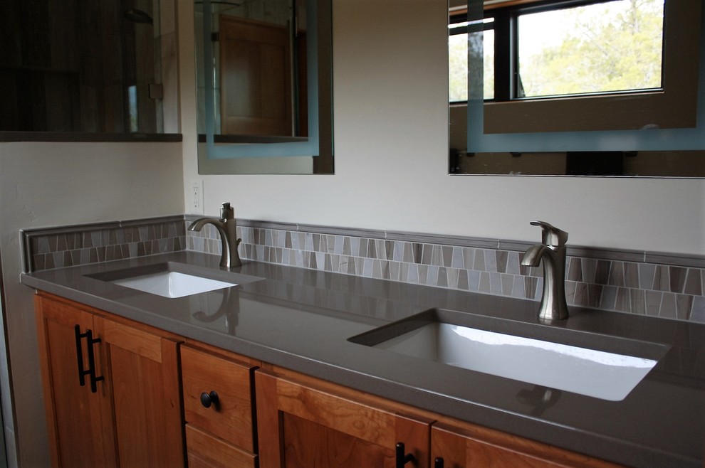 Inspiration for a l-shaped porcelain tile eat-in kitchen remodel with an undermount sink, granite countertops, green backsplash, porcelain backsplash, stainless steel appliances and an island