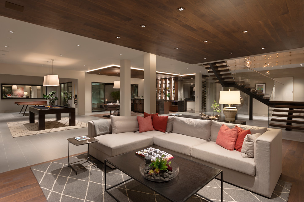 Design ideas for a contemporary open concept living room in Orange County with white walls, dark hardwood floors and brown floor.