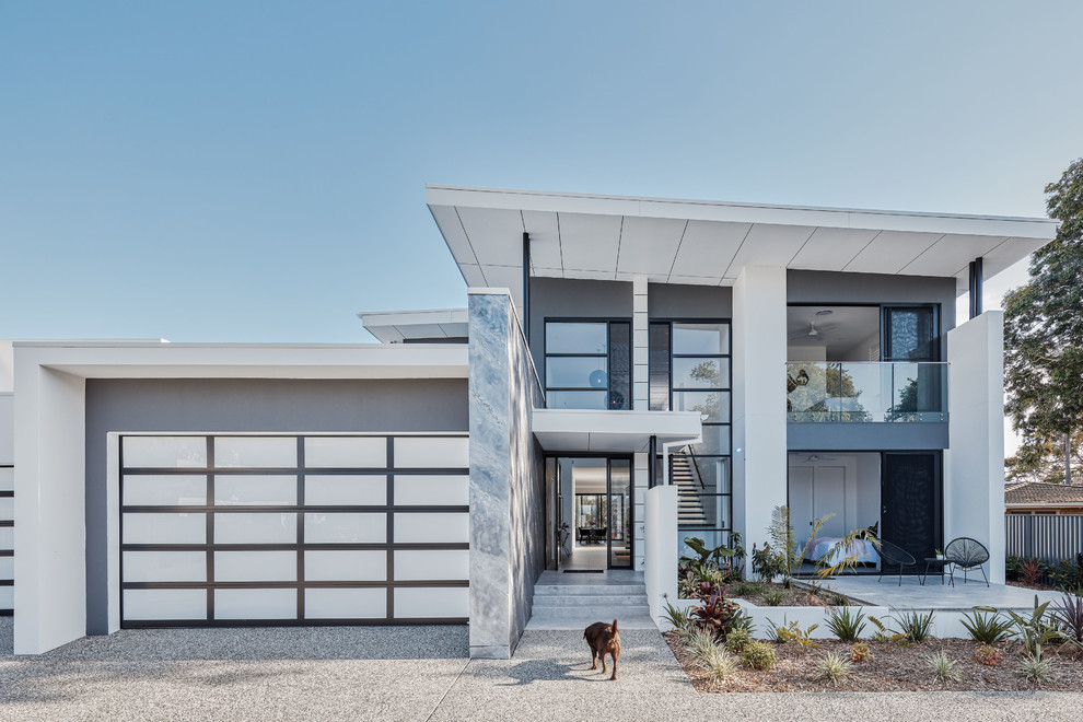 This is an example of a contemporary two-storey grey house exterior in Gold Coast - Tweed with mixed siding and a flat roof.