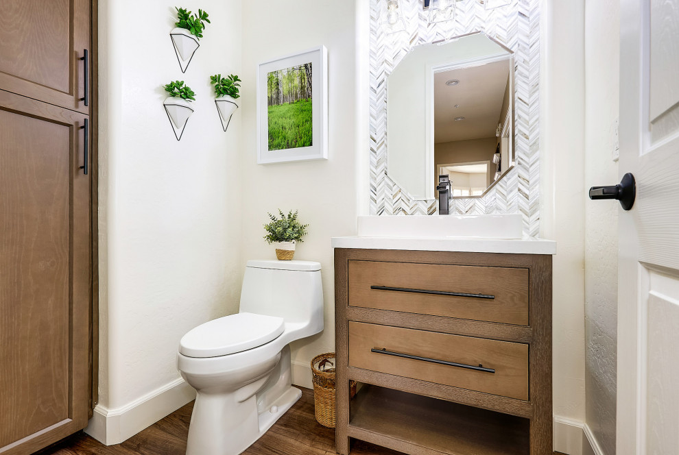 Medium sized traditional cloakroom in Phoenix with medium wood cabinets, a one-piece toilet, multi-coloured tiles, mosaic tiles, white walls, porcelain flooring, engineered stone worktops, brown floors, white worktops, a freestanding vanity unit and a vessel sink.