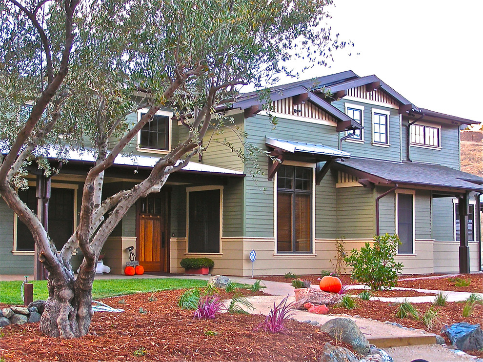 Photo of an expansive arts and crafts two-storey green exterior in San Luis Obispo with wood siding and a gable roof.