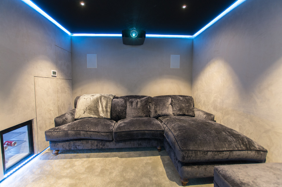 Small contemporary enclosed home theatre in London with carpet, a projector screen and grey walls.