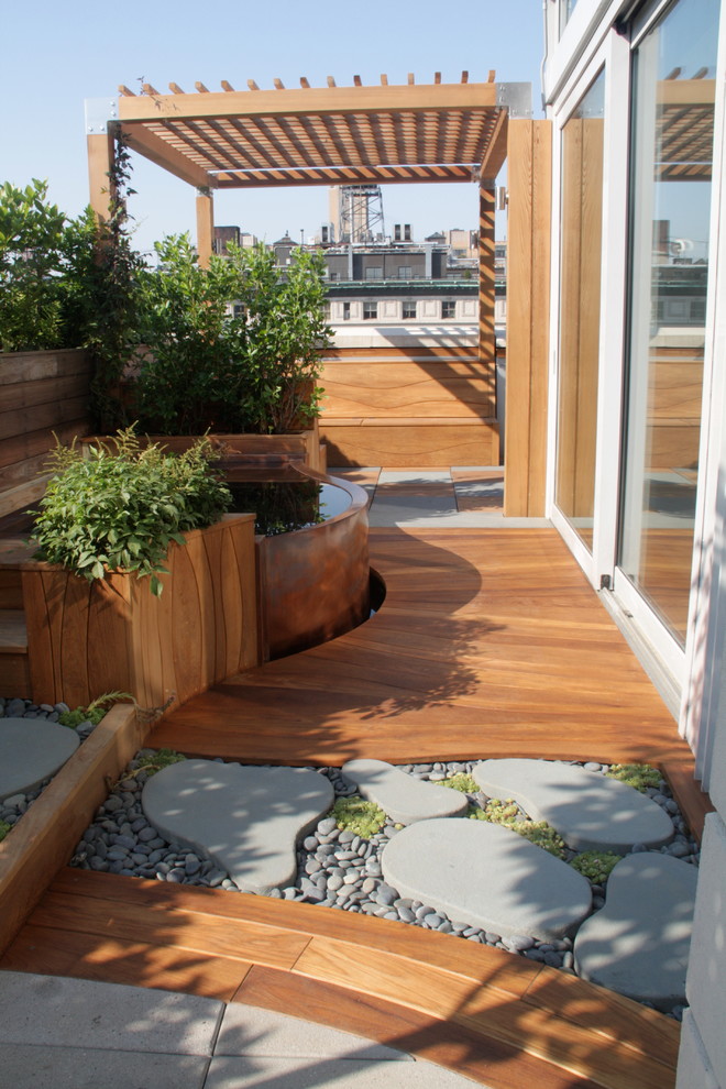 This is an example of a large contemporary rooftop deck in Jacksonville with a water feature and a pergola.