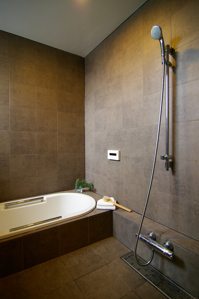 Design ideas for an asian bathroom in Other with a drop-in tub, an open shower, grey walls, grey floor and an open shower.