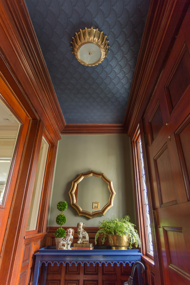 This is an example of a small traditional entryway in Boston with green walls, medium hardwood floors and a single front door.