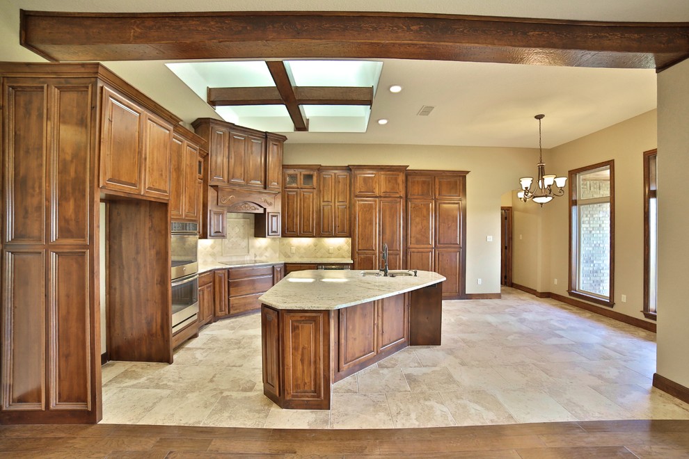 Mid-sized mountain style l-shaped porcelain tile eat-in kitchen photo in Dallas with an undermount sink, raised-panel cabinets, medium tone wood cabinets, granite countertops, beige backsplash, stone tile backsplash, stainless steel appliances and an island