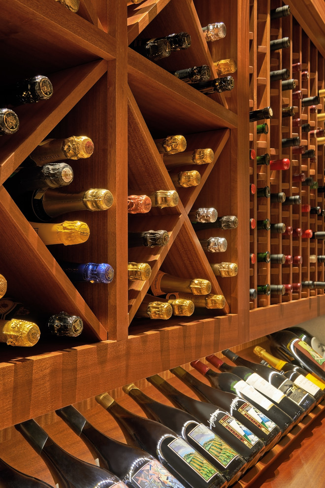 Inspiration for a mid-sized contemporary wine cellar in Portland with concrete floors and diamond bins.