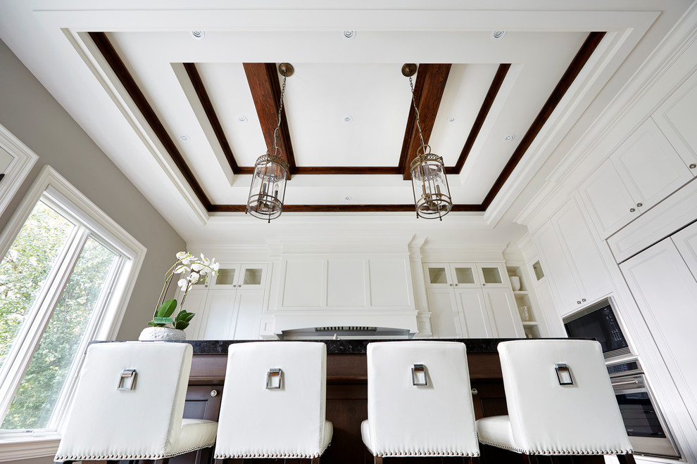 Example of a large transitional l-shaped medium tone wood floor open concept kitchen design in Toronto with recessed-panel cabinets, white cabinets, stainless steel appliances and an island
