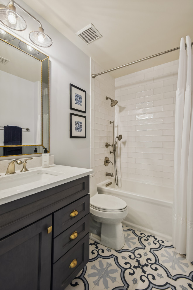 Tub/shower combo - small transitional 3/4 cement tile floor, blue floor and single-sink tub/shower combo idea in DC Metro with shaker cabinets, blue cabinets, white walls, an integrated sink, quartz countertops, white countertops and a floating vanity