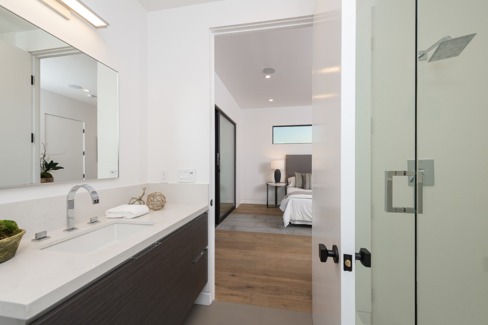 Large modern master bathroom in Los Angeles with grey walls.