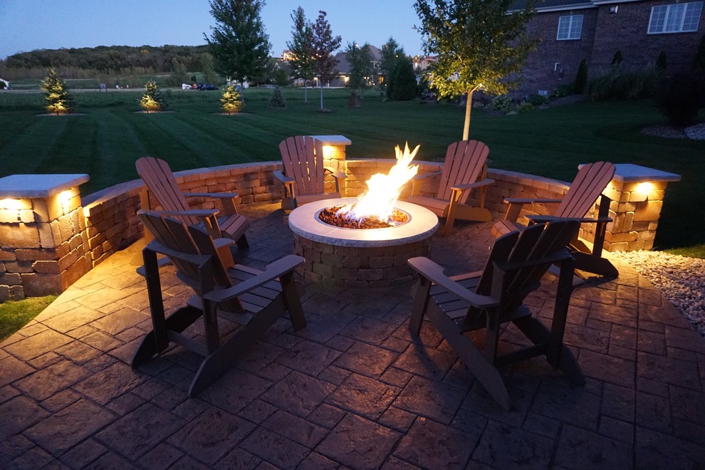 Inspiration for a mid-sized transitional backyard concrete paver patio remodel with a fire pit