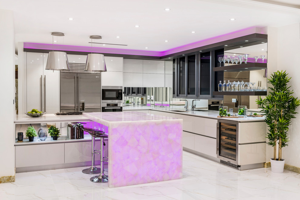 Design ideas for a contemporary l-shaped eat-in kitchen in Brisbane with an undermount sink, flat-panel cabinets, white cabinets, quartz benchtops, metallic splashback, mirror splashback, stainless steel appliances, marble floors and with island.