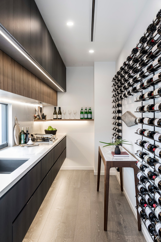 Design ideas for a mid-sized contemporary wine cellar in Gold Coast - Tweed with medium hardwood floors, storage racks and brown floor.